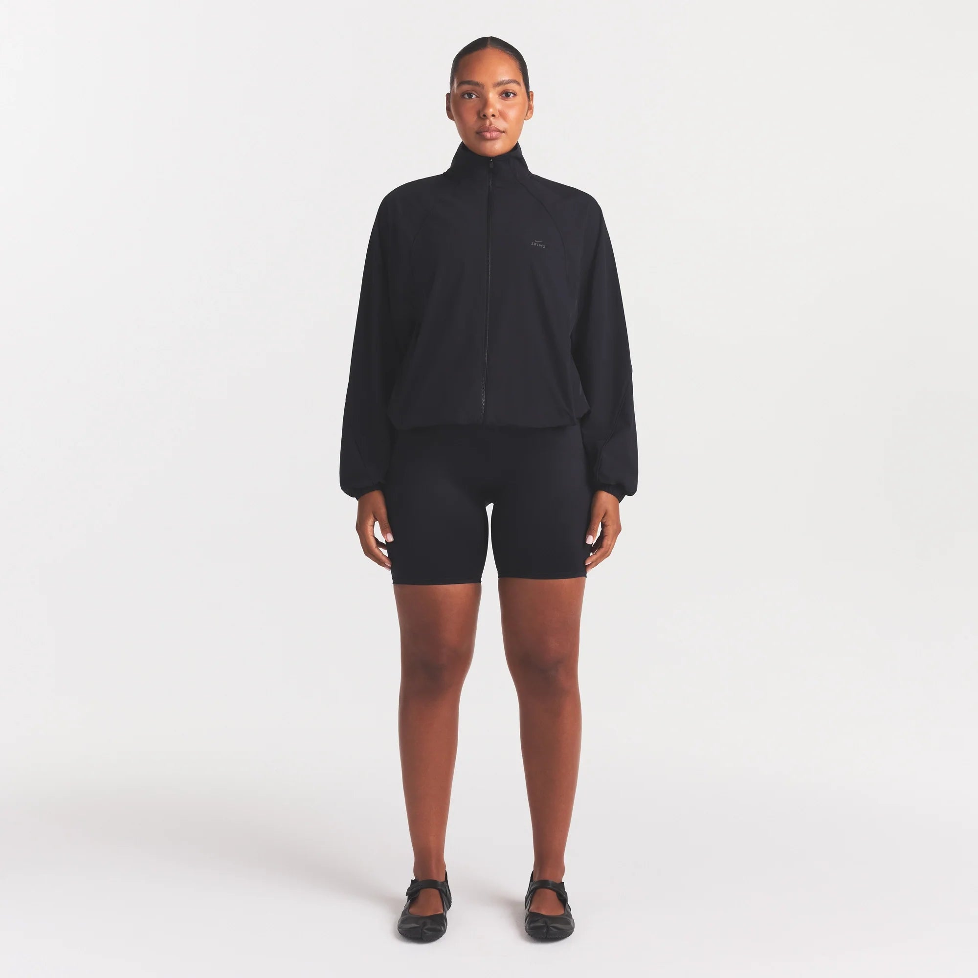 NikeSKIMS STRETCH NYLON OVERSIZED TRACK JACKET | OBSIDIAN