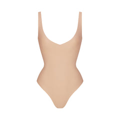 SKIMS BODY UNLINED PLUNGE THONG BODYSUIT | CLAY
